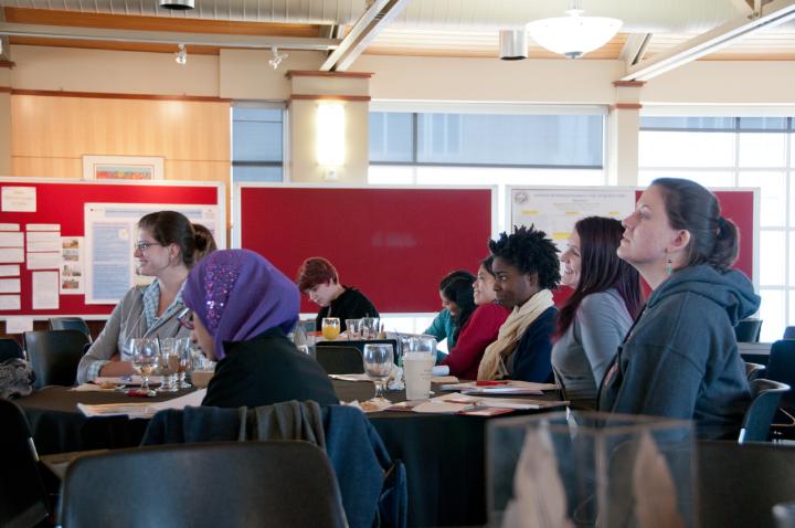 Conference attendees watch presentations