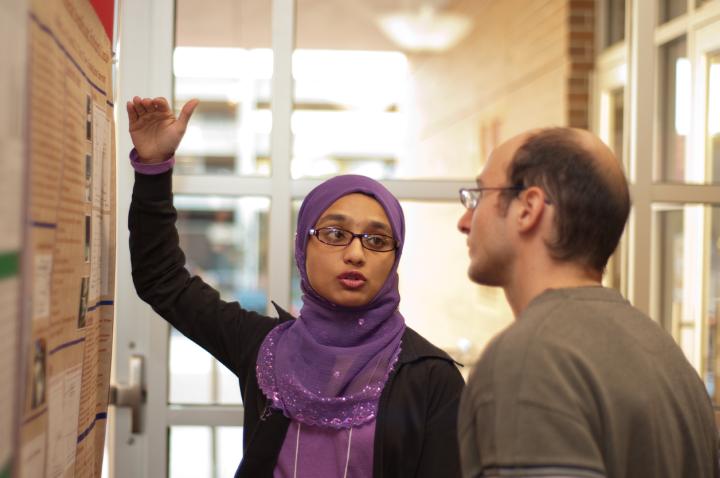 Alex Stamm listens to a student presentation