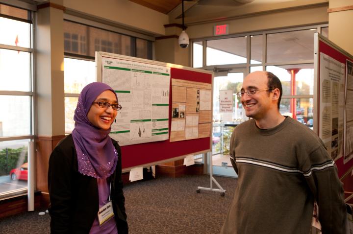 Alex Stamm listens to a student presentation